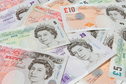 Scattered pound Sterling notes suitable as background